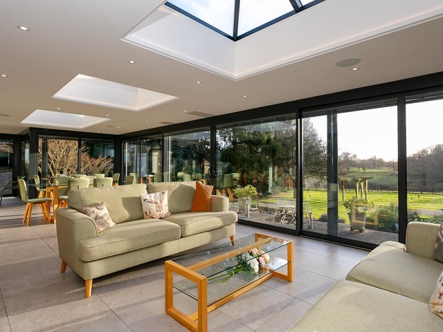 A spacious garden room has extensive views of lawns and countryside.