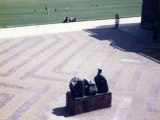 A view looking out over Temple Newsam Park from the courtyard of Temple Newsam House in July 1982. Part of the house is visible on the right. The sculpture seen in the middle of the courtyard is the work of Castleford born sculptor and artist, Henry Moore entitled "Three Piece Reclining Figure Number 1", dating from 1961 to 1962. There were eight bronze casts made of this sculpture which have found a home in museums and galleries at home and abroad.
