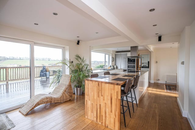 The bright and modern open plan kitchen with diner has stunning views.