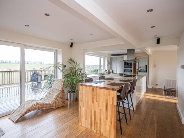 The bright and modern open plan kitchen with diner has stunning views.