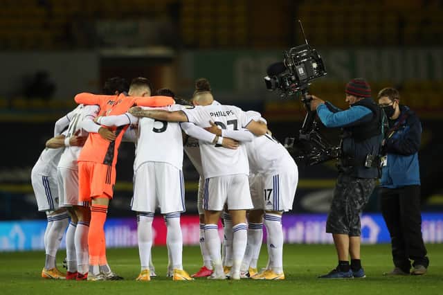 TV cameraman gets a close-up view of the Leeds' huddle ahead of the English Premier League football match between Leeds United and Wolverhampton Wanderers at Elland Road