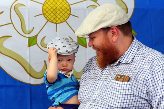 Happy Yorkshire Day - Father and son celebrate the day at Kirkgate Market, Leeds, sporting traditional flat caps