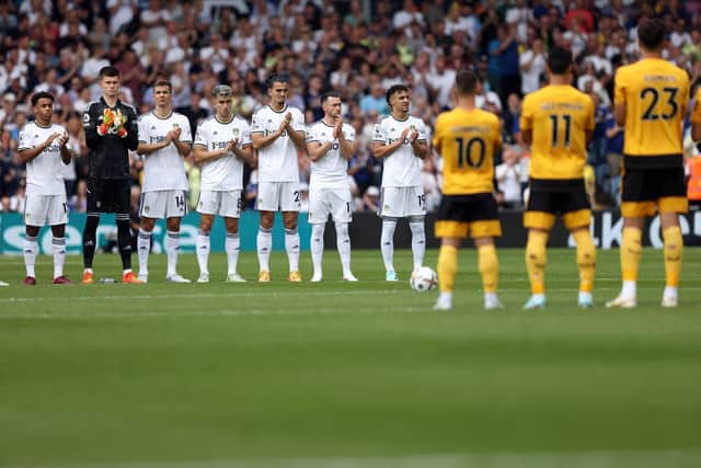 LEEDS, ENGLAND - AUGUST 06:  Players take part in a minutes applause prior to the Premier League match between Leeds United and Wolverhampton Wanderers at Elland Road on August 6, 2022 in Leeds, United Kingdom. (Photo by Marc Atkins/Getty Images)