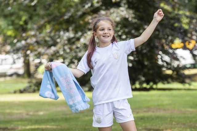 Tess Dolan, 8, has become an Internet sensation after being filmed dancing at the England Women’s game last night in Sheffield, pictured at her home in West Yorks, Jul 27 2022. See SWNS story SWLEfan. A young England fan who captured the hearts of the nation with her joyful celebration is hoping to roar the Lionesses on to Euros success in the final on Wembley. Tess Dolan, eight, warmed the hearts of tv viewers when cameras caught her singing and dancing to Sweet Caroline after England smashed Sweden 4-0 at Bramhall Lane. Now the footy-mad youngster hopes to be at Wembley on Sunday when Sarina Wiegman's side take on the winners of France vs Germany. And while she insists she 'can't predict the future', Tess said: "I have a lot of faith in them to win. I feel like they have a big chance of beating either of them.