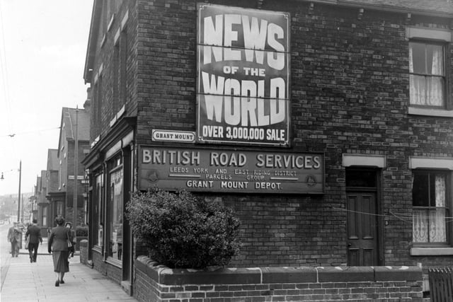 A view looking north-east along the south-east side of Roundhay Road at the corner with Grant Mount in September 1953. On number 3 Grant Mount is an advertisement for News Of The World and a sign for 'British Road Services - Grant Mount Depot'. Behind are numbers 80 and 82 Roundhay Road (B. Colling, tripe dealer, and W. Shawn, glass and china, respectively). Grant Avenue is visible further along.