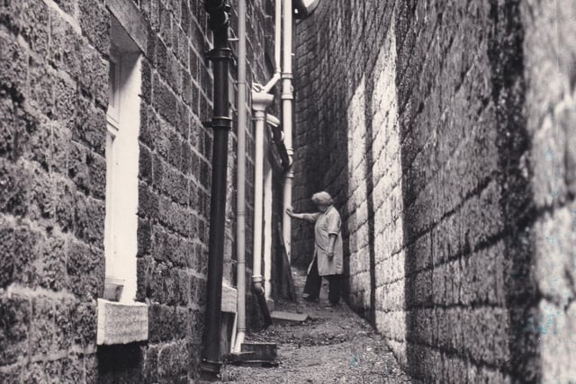 The 'spite and malice' wall overlooking houses in Summersgill Square. Pictured in December 1974.