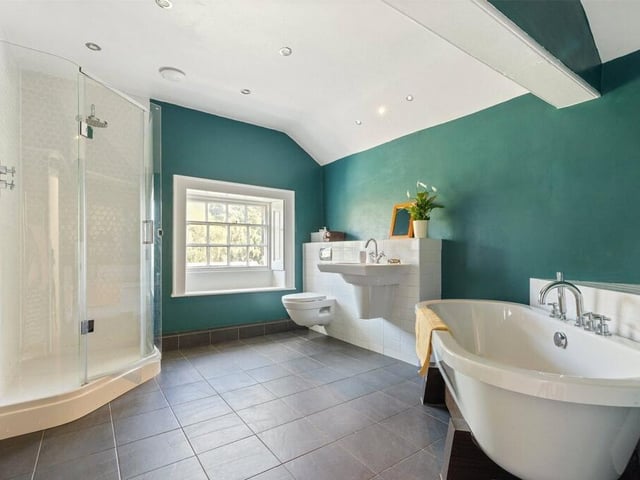 A serene bathroom featuring a freestanding bath and sleek fixtures is designed for ultimate relaxation and style.