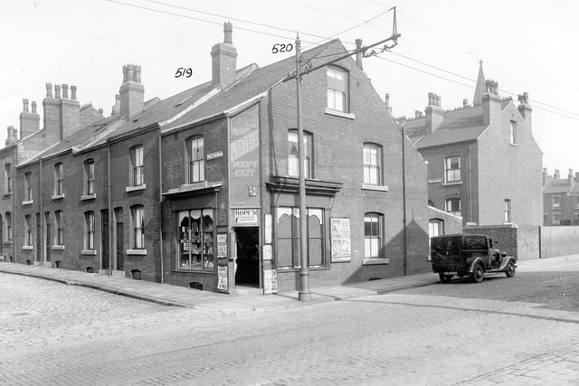 The junction of Stoney Rock Lane and Rock View Road. Hope's Newsagent and Tobacconist is on the corner. There is a large wall advertisement for Players Navy cut cigarettes above the shop doorway. The houses are back to back and the road is made of stone sets with tramlines down the centre. Pictured in September 1935.