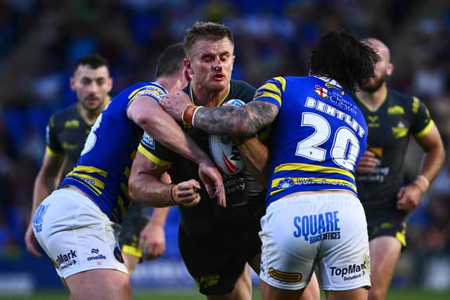 Cooper Jenkins, - seen being tackled by his former teammate James Bentley, now of Warrington Wolves - is having a fine season for Leeds Rhinos. Picture by Olly Hassell/SWpix.com.
