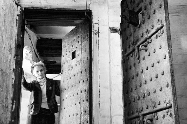 A couple planned to spend their retirement in prison. The Menheneott's, former licensees of an 18th century inn at Ribblehead in the Yorkshire Dales, had bought the Old Court House, jailer's quarters and debtor's and felon's jail. Pictured is Dorothy Menheneott at the entrance to the cells in June 1970.