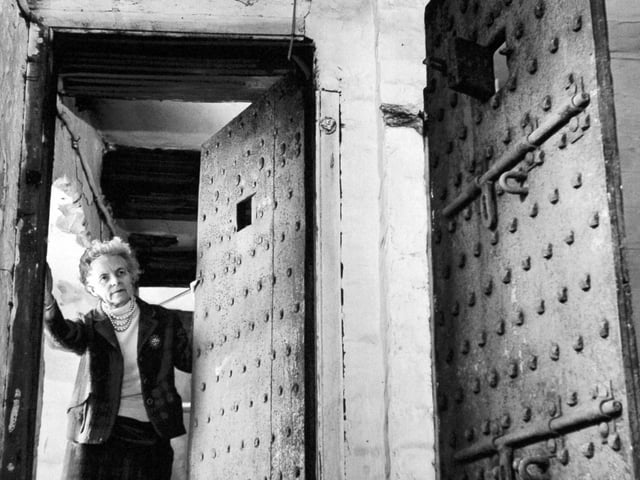 A couple planned to spend their retirement in prison. The Menheneott's, former licensees of an 18th century inn at Ribblehead in the Yorkshire Dales, had bought the Old Court House, jailer's quarters and debtor's and felon's jail. Pictured is Dorothy Menheneott at the entrance to the cells in June 1970.
