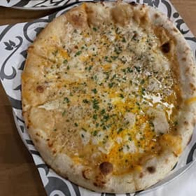 Kirkstall Brewery's Marmite Rarebit pizza features Fior di Latte Mozzarella, Red Leicester, Gran Moravia Parmesan, black pepper, chives, and a rich and savoury bechamel, made from the brewery’s Virtuous IPA spiked with a dollop of Marmite.