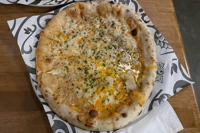 Kirkstall Brewery's Marmite Rarebit pizza features Fior di Latte Mozzarella, Red Leicester, Gran Moravia Parmesan, black pepper, chives, and a rich and savoury bechamel, made from the brewery’s Virtuous IPA spiked with a dollop of Marmite.