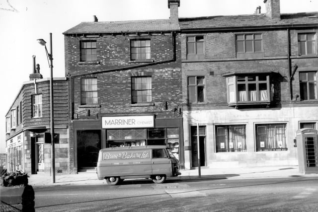 Commercial properties on Woodhouse Lane in March 1966. Number 151 to the left at the corner with Fenton Street is Norman Ratcliffe, dentist. Moving right, number 153 is Robert Marriner's chemists. Number 155 is listed as Samuel Walsh, tailor and number 157 on the rightas National Deposit (Approved) Friendly Society. A sign along the bottom of the window states 'Oxford Committee for Famine Relief'. The parked van belongs to Bray's Bakery Ltd based on Hunslet Road.