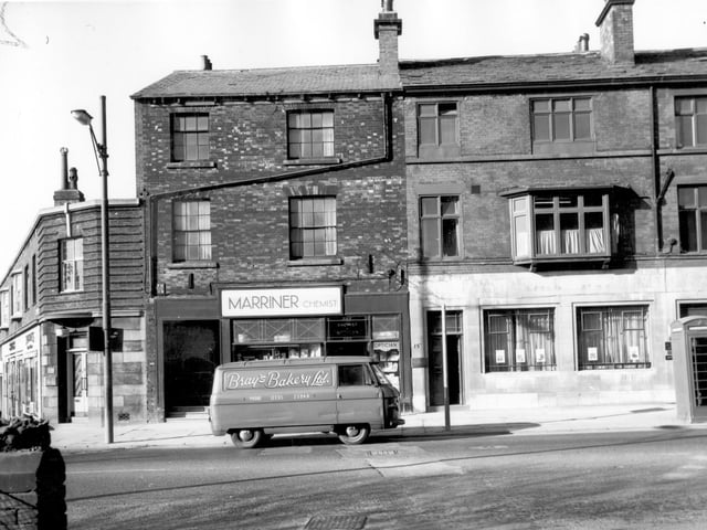 Commercial properties on Woodhouse Lane in March 1966. Number 151 to the left at the corner with Fenton Street is Norman Ratcliffe, dentist. Moving right, number 153 is Robert Marriner's chemists. Number 155 is listed as Samuel Walsh, tailor and number 157 on the rightas National Deposit (Approved) Friendly Society. A sign along the bottom of the window states 'Oxford Committee for Famine Relief'. The parked van belongs to Bray's Bakery Ltd based on Hunslet Road.