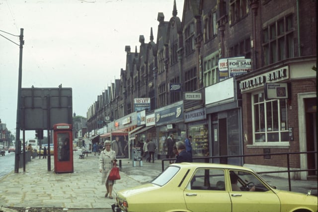 A parade of shops on Roundhay Road known as Harehills Parade. The view looks from the junction with Beck Road, off the picture to the right. The Midland Bank is nearest the camera, followed by an empty shop then W. D. Perkins, confectionery, Boots Chemist, Dewhurst butchers, Thurston’s bakery and Grandways supermarket.
