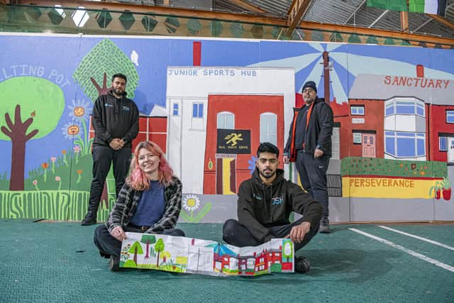 Artist Lily Arnold artist, sat with Danyal Mohammad, Imran Ali and Kamran Khan from the Junior Sports Hub in Harehills with the mural. Photo: Tony Johnson