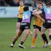 Castleford Tigers' George Lawler is tackled by James Bell and Harry Newman of Hull FC. Picture by John Clifton/SWpix.com.