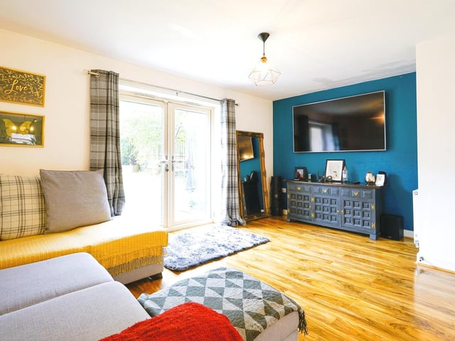 Arranged over three floors, the home boasts plenty of charming features including exposed brick, lovely wooden furnishings and art painted onto the walls.