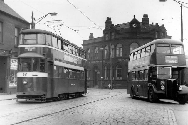 Tong Road at the junction with Wellington Road in July 1956. To the left of the Yorkshire Penny Bank, and Copley Hill, to the right. The Crown Meat Market at no.6 Tong Toad can be seen on the left. A tram and a bus are on the road : the tram is a Feltham, no.567, on the Cross Gates route 18, while the bus is bound for Lower Wortley.