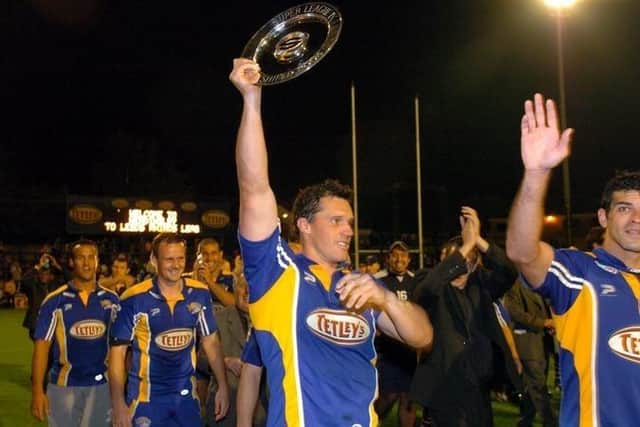 Matt Adamson lifts the Super League leaders' shield in 2004 during his spell as a player with Leeds Rhinos. Picture by Steve Riding.