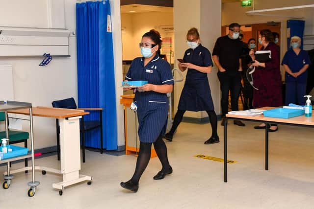 Nurse May Parsons carries a dose of the PCovid-19 vaccine to inoculate Margaret Keenan at University Hospital in Coventry (Photo: JACOB KING/POOL/AFP via Getty Images)