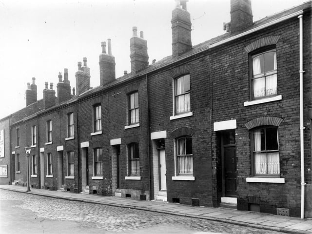 Prospect Street located between Beza Street and Gasholder Road in July 1961. This view looks towards Beza Street. This odd numbered side of the street begins with 1A on the left and ends with 13 on the right.