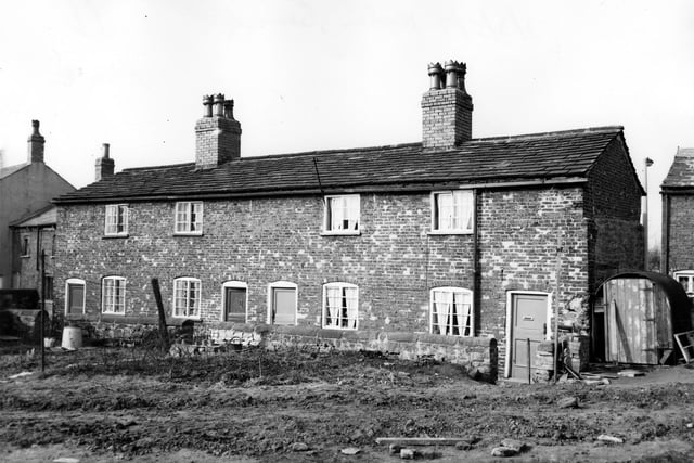 The Nookin, a row of old red brick terraced cottages  seen from the direction of Barwick Road. They were located close to the roundabout on the ring road at the junction with Barwick Road. These cottages were owned at the time of the photograph in March 1964 by Messrs Mawson & Walton.