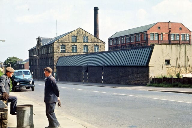 This photograph of Britannia Mills on Britannia Road in August 1965 was taken after the mill was closed but prior to any demolition taking place. The mill belonged to William Baines and Sons Ltd. The earliest building was the three storey block with central hoist along the roadside which dated from 1860 and is shown as a lithograph in William Smith's 'Rambles About Morley' of 1866. The long, low weaving shed by its side dates from the late nineteenth century. Behind these two is a more modern red brick structure very like several of the same type at other Morley mills.