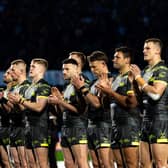 Leeds Rhinos players take part in a minute's applause in memory of Geoff Burrow ahead of their derby at Bradford Bulls. Picture by Alex Whitehead/SWpix.com.