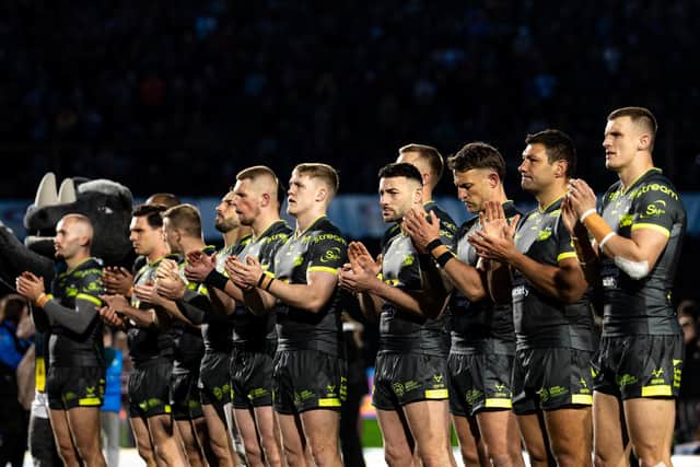 Leeds Rhinos players take part in a minute's applause in memory of Geoff Burrow ahead of their derby at Bradford Bulls. Picture by Alex Whitehead/SWpix.com.