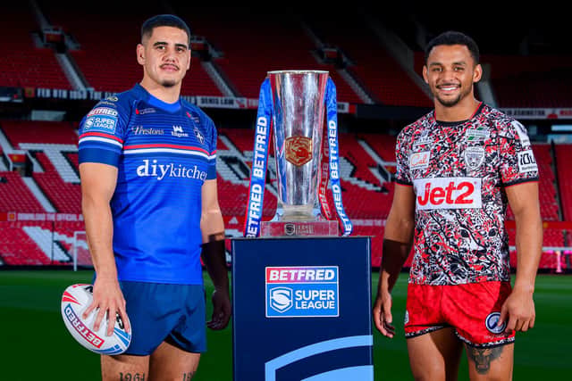 Wakefield Trinity's Caleb Hamlin-Uele and Leigh Leopards' Umyla Hanley with the Betfred Super League trophy at Old Trafford this week. Picture by Allan McKenzie/SWpix.com.