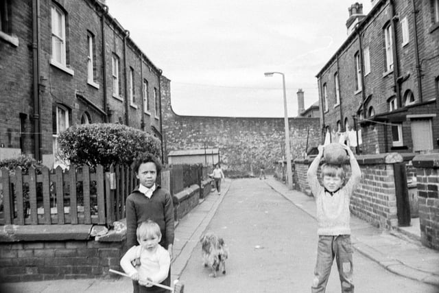 Children playing at the junction of Queen's Road and Branksome Street (the short street of terraced housing seen in the background).