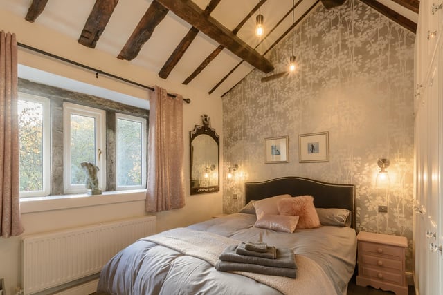 Open ceiling beams add character to this charming bedroom.