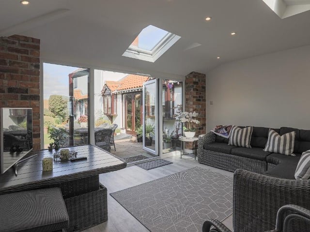 The sitting room is ideal for relaxation and perfect for enjoying the views of the gardens.