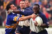 Eddie Rombo, right, playing for Featherstone, is tackled by Leeds' Phil Hassan. Picture by Steve Riding.