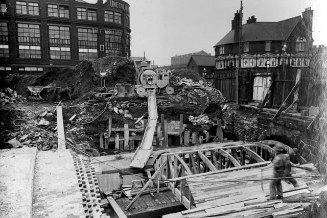 The Lloyds Arms is to the left of this photo from April 1937. It focuses on the covering-in of Lady Beck and the construction method used, note the use of the wooden arch template. At the centre is a concrete mixer and slide.