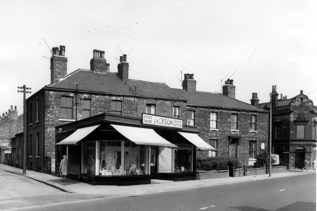Looking across Dewsbury Road to private housing and shop property. A woman is walking up Bewerley Street on the left. The one storey shop premises is Jackson's bespoke tailor and ladies and gents outfitter.