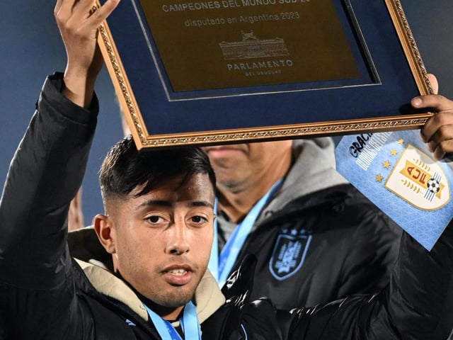 Uruguay's midfielder and Under-20 team captain Fabricio Diaz holds a comemorative plaque the team was awarded from the Uruguayan Parliament after winning the U-20 World Cup this month (Photo by Eitan ABRAMOVICH / AFP) (Photo by EITAN ABRAMOVICH/AFP via Getty Images)
