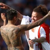 BRENTFORD, ENGLAND - MAY 22: Kalvin Phillips (R) and Raphinha of Leeds United celebrate avoiding relegation and their side's victory in the Premier League match between Brentford and Leeds United at Brentford Community Stadium on May 22, 2022 in Brentford, England. (Photo by Ben Hoskins/Getty Images)