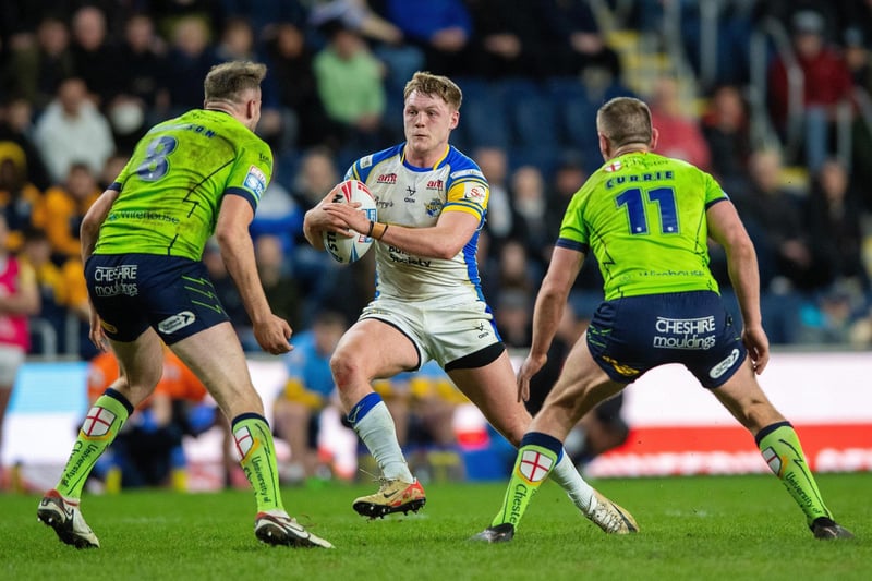 Rhinos forward James McDonnell takes on Warrington's James Harrison and Ben Currie.