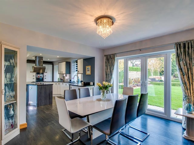 Open plan dining with doors out to a patio area and the wider garden.