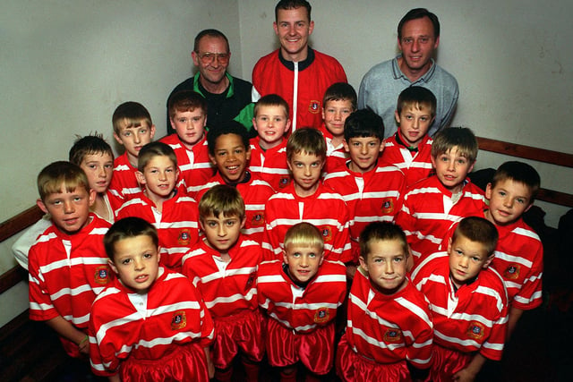 East Leeds Amateur Rugby League U-10s are pictured with their coach Jon Miller (centre) and sponsors Les Barratt (left) and Kevin Worrall (right) in October 1996.