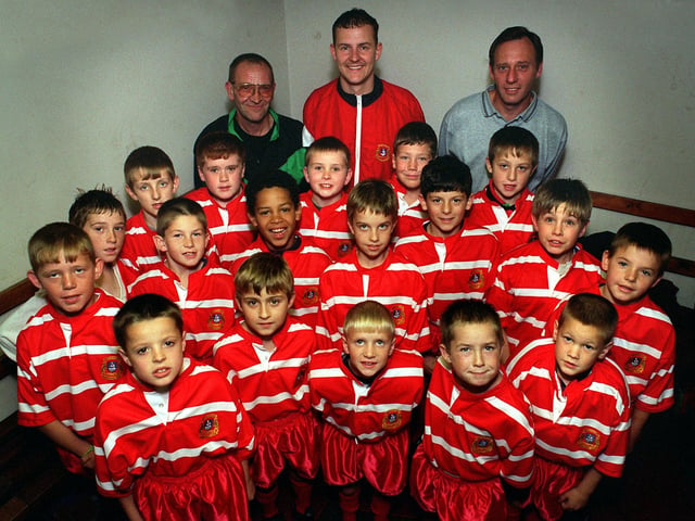 East Leeds Amateur Rugby League U-10s are pictured with their coach Jon Miller (centre) and sponsors Les Barratt (left) and Kevin Worrall (right) in October 1996.