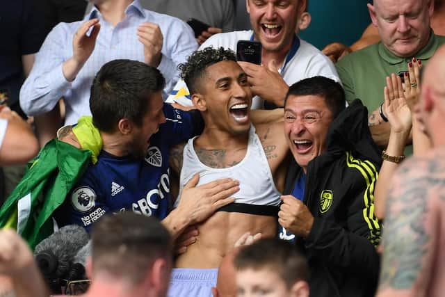 BRENTFORD, ENGLAND - MAY 22: Raphinha of Leeds United celebrates with the fans after avoiding relegation following victory in the Premier League match between Brentford and Leeds United at Brentford Community Stadium on May 22, 2022 in Brentford, England. (Photo by Alex Davidson/Getty Images)