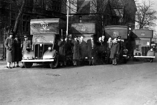 Mobile Canteens parked in front of council offices on Marsh Street in April 1941. It was on the occasion of Rothwell Urban District Council, Mobile Canteens fund Presentation. Pictured, from left, are three Y.M.C.A. representatives, Mrs Hindle, Mrs Mainley, F. Butterick, Mrs Melvin, W. McCullough, Coun E.Howroyd, Coun A. Armitage, J.P. (chairman of the Council), Coun G.Caygill, Coun W. Parker, Coun W.E. Moorhouse (chairman of the Appeals Committee) and a Salvation Army Captain.