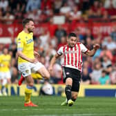 PREVIOUS: Whites duo Stuart Dallas, left, and Liam Cooper, right, look on as Neal Maupay nets for Brentford in the Championship clash against Leeds United of April 2019 at Griffin Park. Photo by Bryn Lennon/Getty Images.