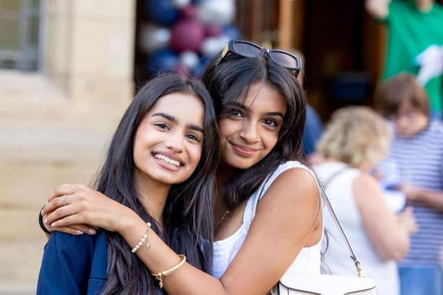 Ayesha celebrates with her friend Priya Gill, of Pudsey, near Leeds,