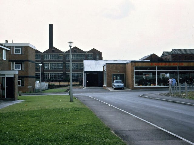 After the last vestiges of Jackson Lane were cleared away at the end of 1963 the redevelopment of the area took place quite rapidly with new street patterns being laid out besides the new housing. Here can be seen the new showrooms for W. Mountain and Son, horticultural machinery suppliers, from the flats at the side of the former Cross Church Street (now Church Way). The 1934 Prospect Mill Building and older chimney is to be seen in the background. The area in the foreground used to be a warren of old yards which were all swept away and Jackson Lane itself was renamed Bank Avenue.