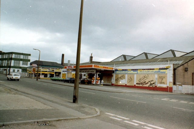 Harehills Lane showing Troy Garage, boarded up for protection as a result of riots in the area, but proclaiming Business As Usual.